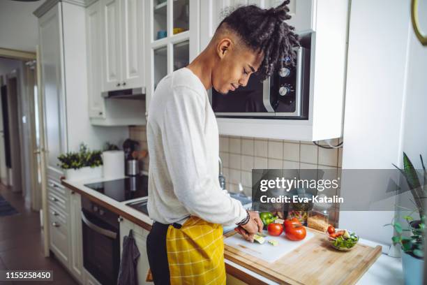 in the kitchen - man cooking stock pictures, royalty-free photos & images