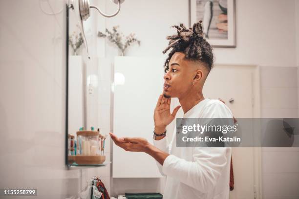 at home - young man brushing his teeth - mens toiletries stock pictures, royalty-free photos & images