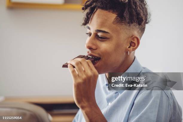 at home - young man brushing his teeth - black man eating chocolate stock pictures, royalty-free photos & images