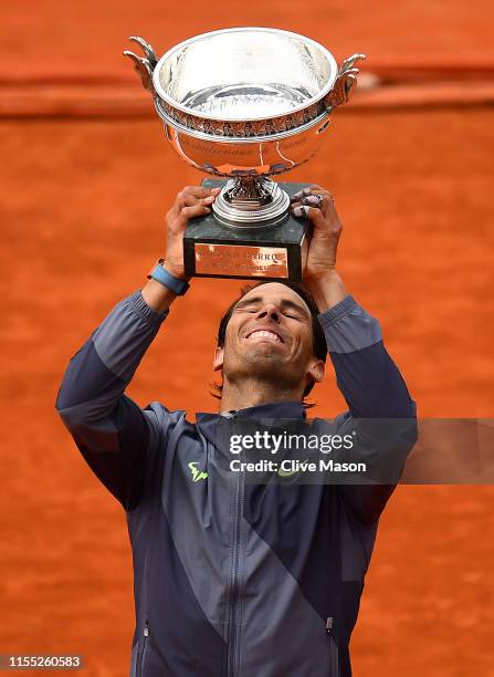 Rafael Nadal of Spain celebrates with the trophy following the mens singles final against Dominic Thiem of Austria during Day fifteen of the 2019...