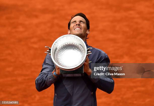 Rafael Nadal of Spain celebrates with the trophy following the mens singles final against Dominic Thiem of Austria during Day fifteen of the 2019...