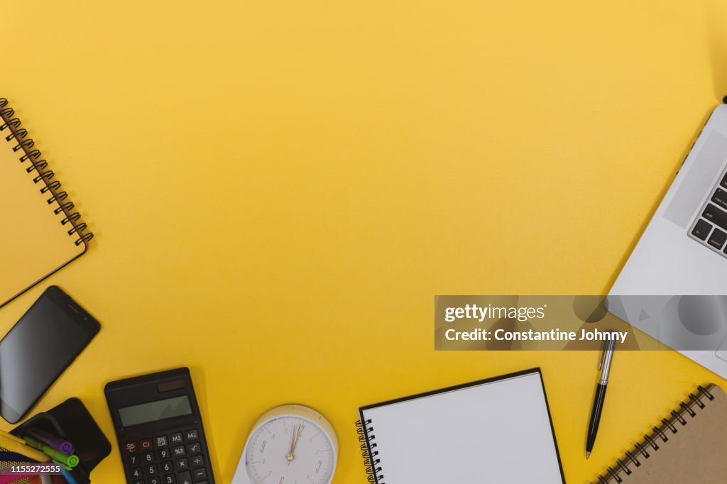 Office Supply Items on Yellow Work Desk