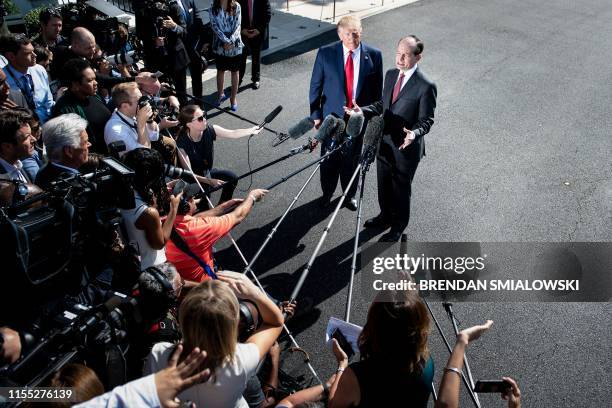 President Donald Trump listens to US Labor Secretary Alexander Acosta during a media address early July 12, 2019 at the White House in Washington,...