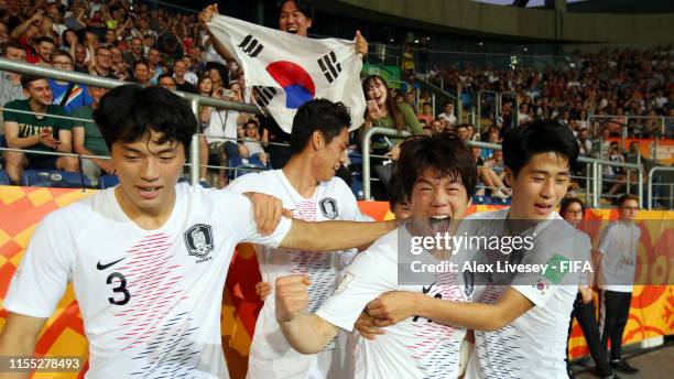 Jun Choi of Korea Republic celebrates with team mates after scoring his team's first goal during the 2019 FIFA U-20 World Cup Semi Final match...