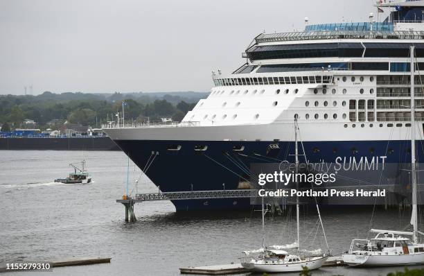 June 25: A lobster boat motors past the cruise ship Celebrity Summit docked in Portland Harbor Tuesday, June 25, 2019.