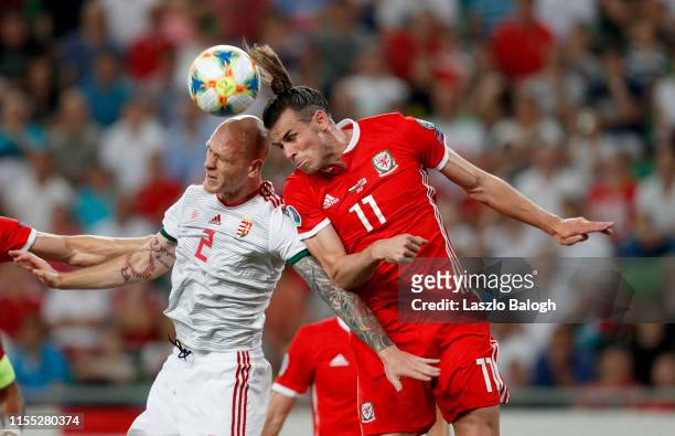 Botond Barath of Hungary and Gareth Bale of Wales compete for a header during the UEFA Euro 2020 Qualifier between Hungary and Wales at Groupama...