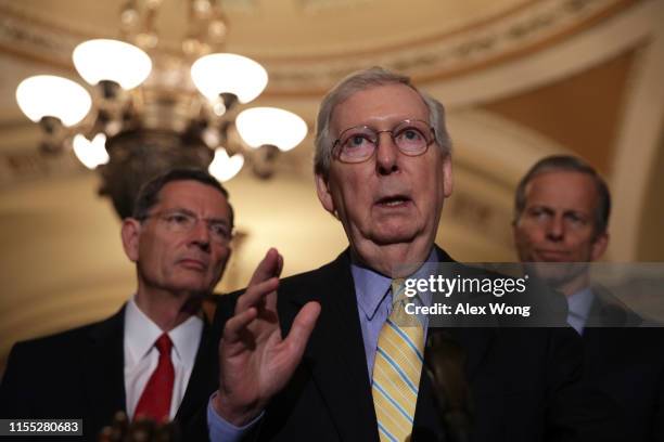 Senate Majority Leader Mitch McConnell speaks as Sen. John Barrasso and Senate Majority Whip John Thune listen during a news briefing after the...