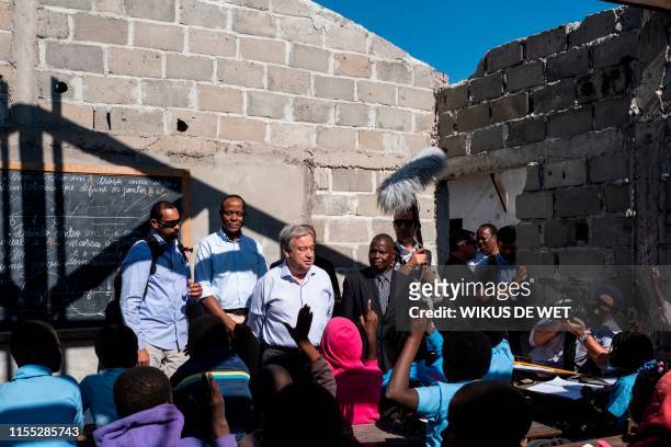 Antonio Guterres, the United Nations Secretary General, speaks to children in a classroom Escola 25 de Juhno in Munhava that was damaged during...