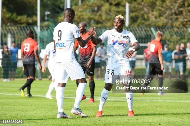 Sehrou Guirassy of Amiens celebrates with Ulrick Eneme Ella during the pre-season friendly match between Amiens and Boulogne-sur-mer on July 12, 2019...