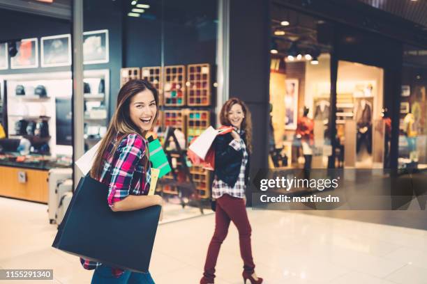 girls in the shopping mall - black friday sale stock pictures, royalty-free photos & images