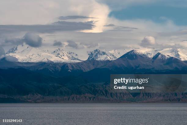 tien shan mountains and lake issyk-kul in kyrgyzstan. - lake issyk kul stock pictures, royalty-free photos & images