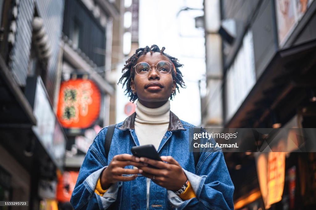 African Woman With Smartphone Vacationing in Tokyo