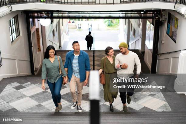 friends walking up old arcade stairs - new zealand people stock pictures, royalty-free photos & images