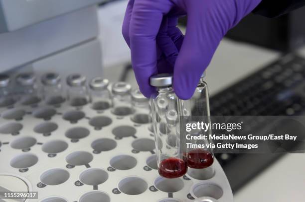 Joaquin Jimenez, forensic supervisor with the Contra Costa County Sheriff's Crime Lab, shows how containers of blood and air are loaded into a...