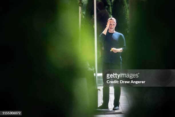 Mark Zuckerberg, chief executive officer of Facebook, applies sunscreen at the annual Allen & Company Sun Valley Conference, July 12, 2019 in Sun...