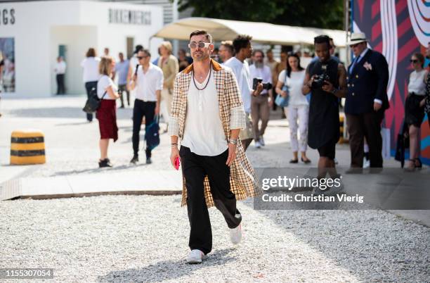 Alex Badia is seen wearing plaid coat during Pitti Immagine Uomo 96 on June 11, 2019 in Florence, Italy.