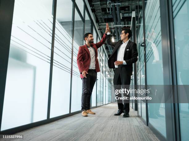 cheerful business partners high five - high five office stock pictures, royalty-free photos & images