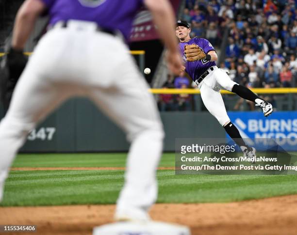 Colorado Rockies third baseman Ryan McMahon throws toColorado Rockies first baseman Daniel Murphy , throwing out Chicago Cubs catcher Willson...