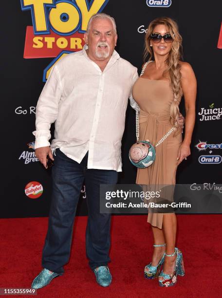John Ratzenberger and Julie Blichfeldt attend the Premiere of Disney and Pixar's "Toy Story 4" on June 11, 2019 in Los Angeles, California.