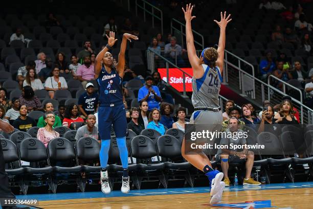 Atlanta's Tiffany Hayes shoots a three pointer while guarded by Minnesota's Napheesa Collier during the WNBA game between the Minnesota Lynx and the...