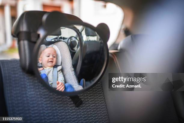 baby boy in a car safety seat - baby car seat stock pictures, royalty-free photos & images