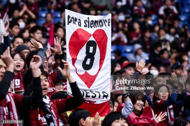 Fans of Vissel Kobe cheer during the J.League J1 match between Gamba Osaka and Vissel Kobe at Panasonic Stadium Suita on March 30, 2019 in Suita,...