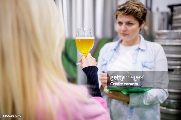 checking clearness of beer - fermenting tank stock pictures, royalty-free photos & images