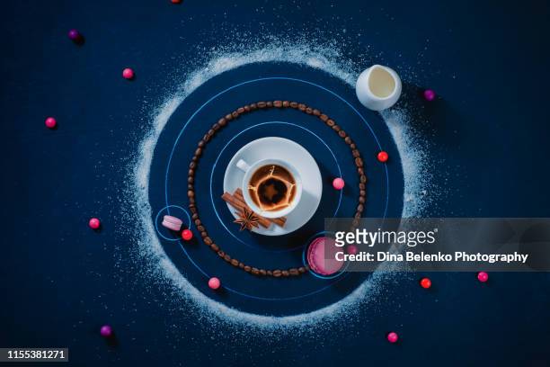 coffee solar system. a galaxy formed with coffee cup, macaroon cookies, sugar, and candies. astronomy flat lay, creative food photo. - macaroon stock pictures, royalty-free photos & images