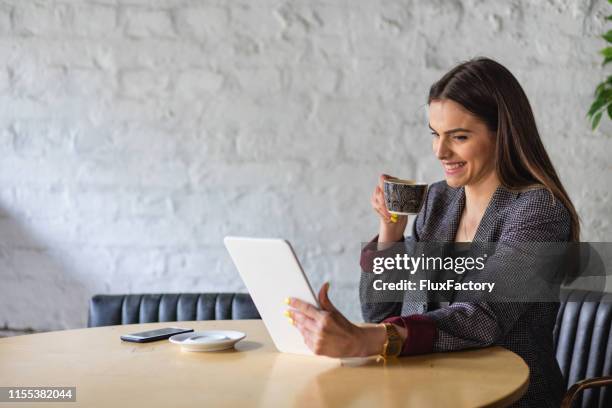 elegant young woman having coffee time with her friend on video call - saleswoman stock pictures, royalty-free photos & images