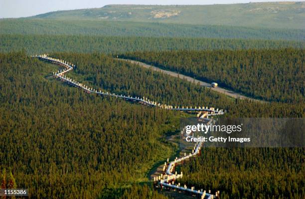 Fuel truck drives south along the Trans-Alaska Pipeline late on July 21, 2002 between the Yukon River and The Arctic Circle on Dalton Hwy. The 800...