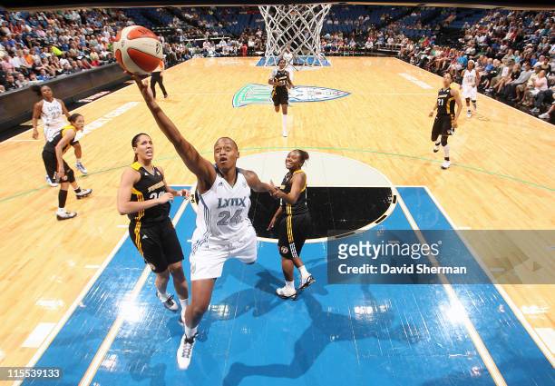 Charde Houston of the Minnesota Lynx goes for the layup against Miranda Ayim and Andrea Riley of the Tulsa Shock during the game on June 7, 2011 at...