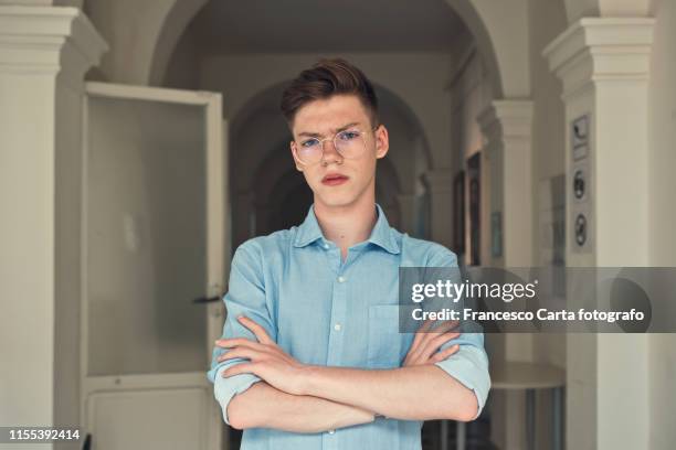 angry teenage boy - annoyed face brunnette stock-fotos und bilder