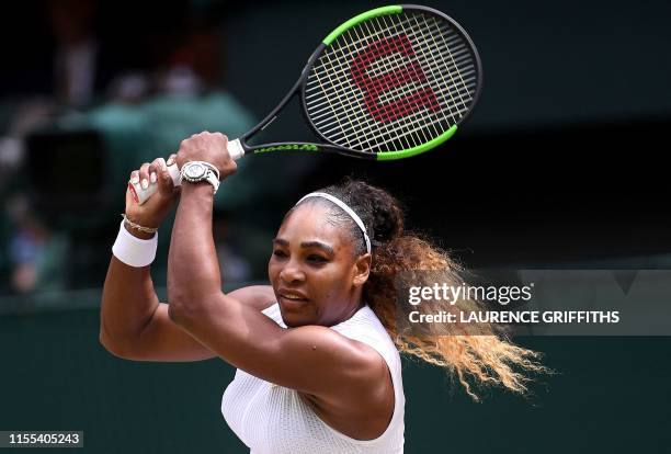 Player Serena Williams returns against Romania's Simona Halep during their women's singles final on day twelve of the 2019 Wimbledon Championships at...