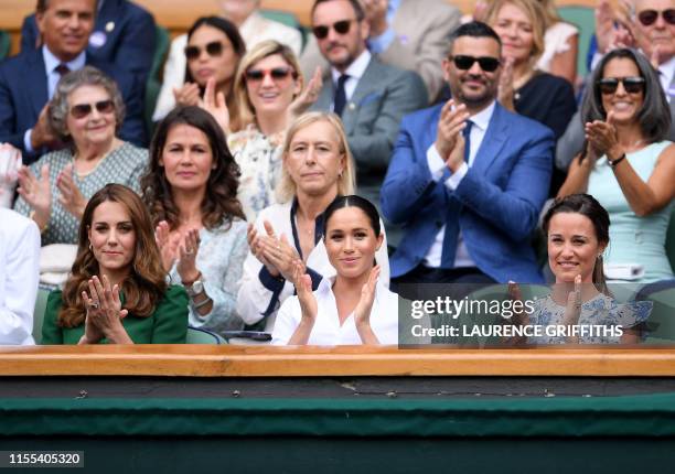Britain's Catherine , Duchess of Cambridge and Britain's Meghan , Duchess of Sussex, watch Romania's Simona Halep playing US player Serena Williams...