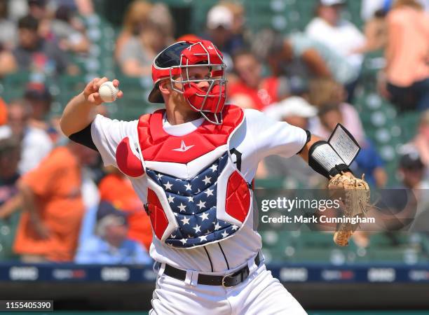 John Hicks of the Detroit Tigers throws a baseball while wearing red, white and blue catchers gear to honor 4th of July weekend during the game...