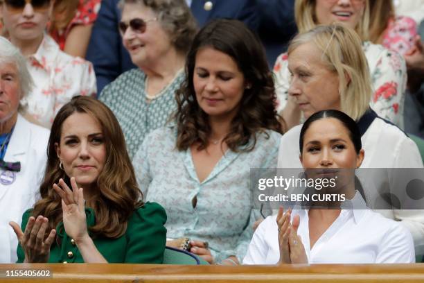 Britain's Catherine , Duchess of Cambridge and Britain's Meghan, Duchess of Sussex, watch Romania's Simona Halep playing US player Serena Williams...