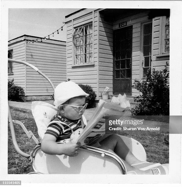 toddler in his buggy, reading newspaper - bush baby bildbanksfoton och bilder