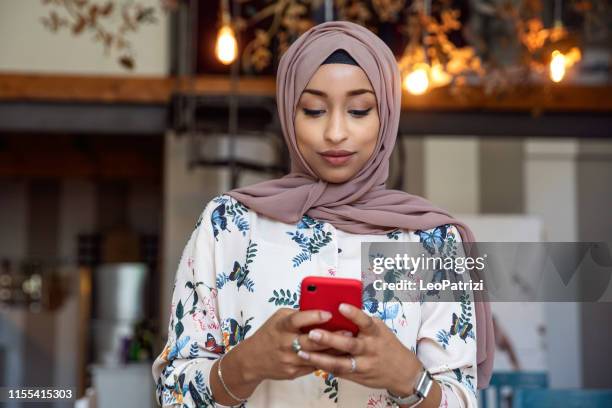 arab italian texting on mobile and scrolling social media - cute arab girls stock pictures, royalty-free photos & images