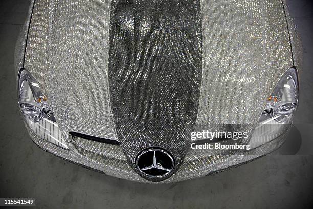 Daimler AG Mercedes Benz adorned with crystals sits in a garage during the Shanghai International Circuit Club Challenge, in Shanghai, China, on...