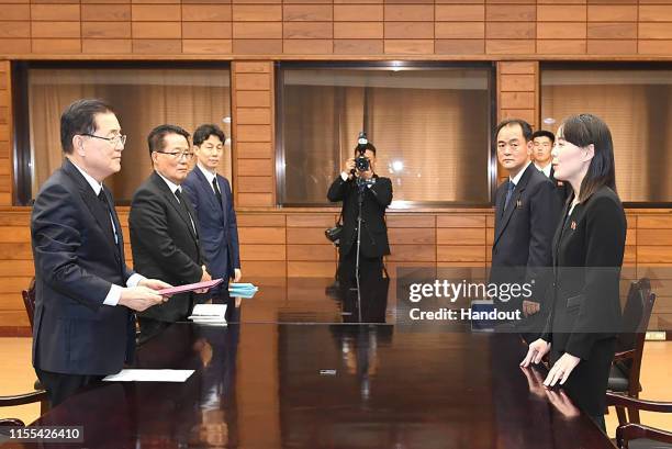 In this handout photo provided by the Ministry of Unification, Kim Yo-Jong , sister of North Korean leader Kim Jong Un, talks with Chung Eui-yong ,...