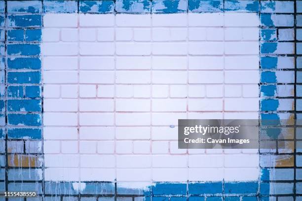 brick wall painted blue with a pinky white square in the center - pink colour scheme stock pictures, royalty-free photos & images