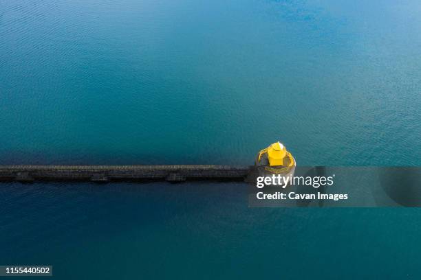stone wall and construction between water - marker buoy stock pictures, royalty-free photos & images