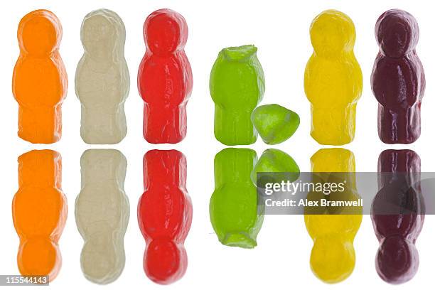jelly babies with one candy figure headless - gummi bears stockfoto's en -beelden