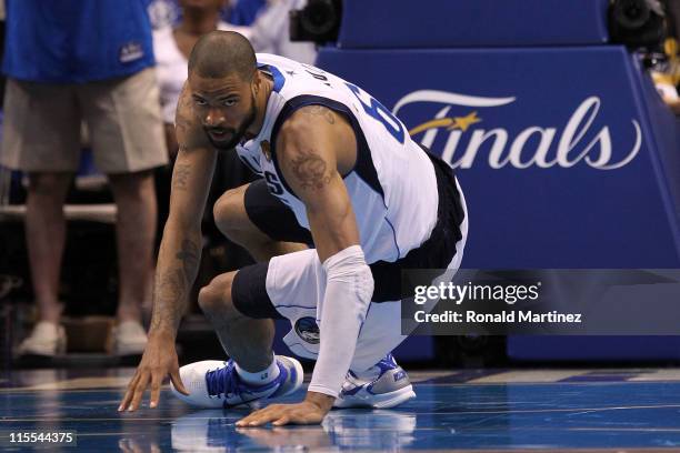 Tyson Chandler of the Dallas Mavericks picks himself up off the court against the Miami Heat in Game Four of the 2011 NBA Finals at American Airlines...