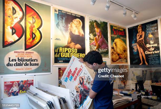 Man looks at a poster of a movie with French actress Brigitte Bardot during the exhibition "The Bardot years 1952-1973" at Orsay Gallery on June 12,...