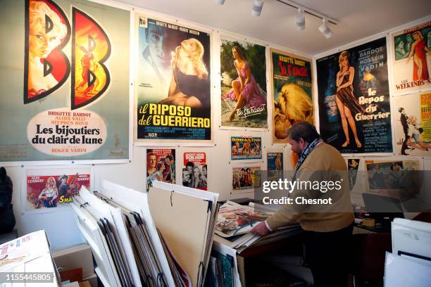 An expert on old posters, Frederic Lozada looks at a poster of a movie with French actress Brigitte Bardot during the exhibition "The Bardot years...