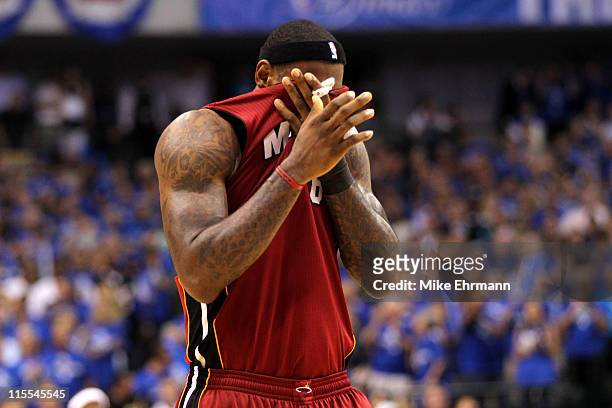 LeBron James of the Miami Heat wipes his face with his jersey against the Dallas Mavericks in Game Four of the 2011 NBA Finals at American Airlines...