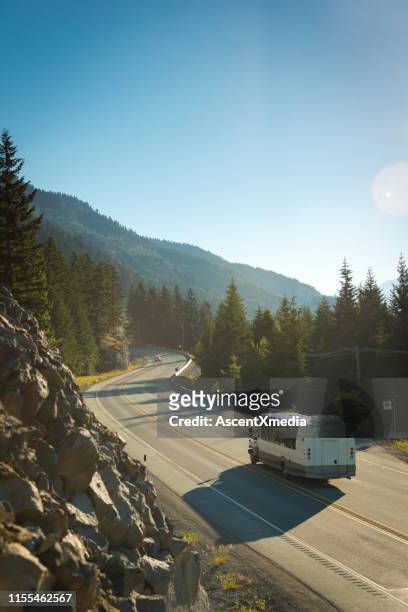 bus driving the sea to sky highway south of whistler - shuttle bus stock pictures, royalty-free photos & images