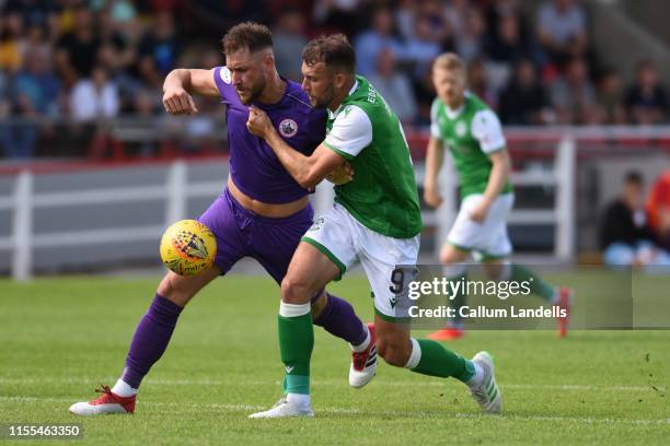 Ross McGeachie of Stirling Albion and Christian Doidge of Hibernian battle it out during the Scottish League Cup match between Stirling Albion and...