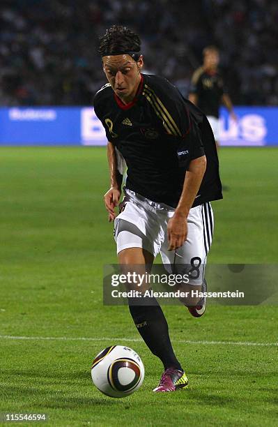 Mesut Oezil of Germany runs with the ball during the UEFA EURO 2012 qualifying match between Azerbaijan against Germany at Tofig-Bahramov-Stadium on...